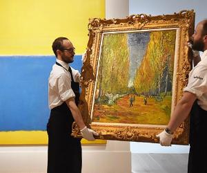 Museum curators holding a Van Gogh painting | Mary Turner/GettyImages