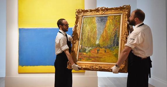 Museum curators holding a Van Gogh painting | Mary Turner/GettyImages