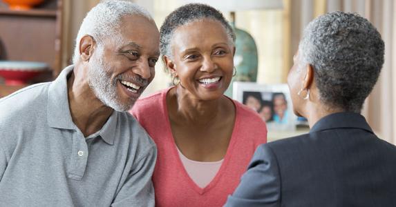 When is it best to refinance a reverse mortgage? Older couple shaking hands with adviser in home | Ariel Skelley/Blend Images/Getty Images