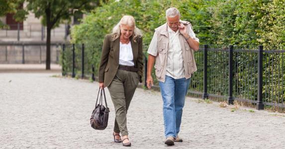 Couple walking together in city park © iStock