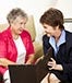 Older couple young salesperson reviewing information © Lisa F. Young/Shutterstock.com