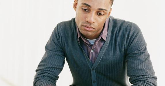 What's the best way to pay student loans? Pensive young man in grey cardigan | Digital Vision/Photodisc/Gettty Images