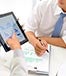 People using tablet to analyze charts © Dragon Images/Shutterstock.com