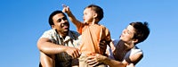 A family with blue sky behind them 