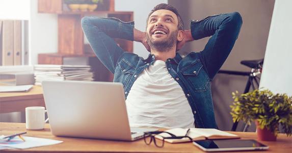 5 things you must know about 401(k)s Happy man leaning back in chair © g-stockstudio/Shutterstock.com