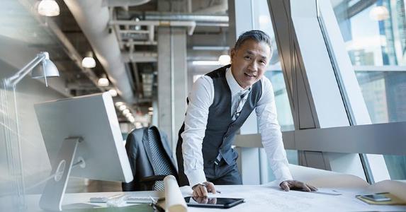 What are the Roth IRA rules? Professionally dressed man in modern office | Hero Images/Getty Images