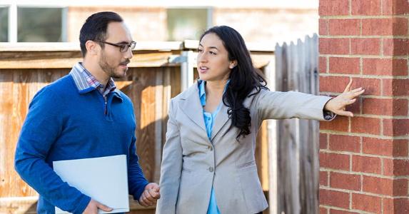 Calculating the cost basis of a long-time family property Realtor showing property | asiseeit/Getty Images