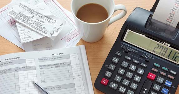 How long should you keep tax records? Receipts with bookkeeping ledger and calculator © RTimages / Fotolia