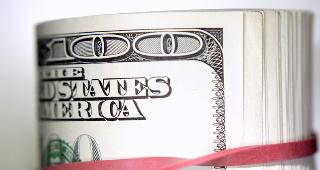 Roll of $100 bills © STILLFX/Shutterstock.com