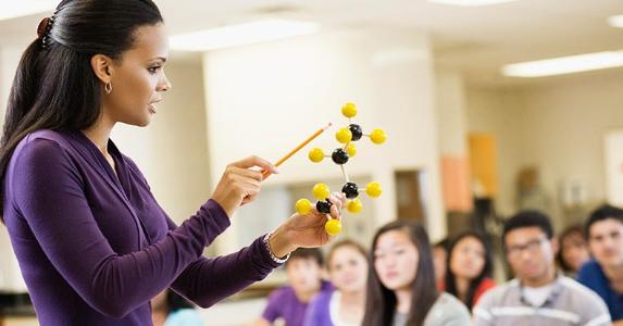 Teachers can write off educator expenses Science teacher in class | Jon Feingersh/Getty Images