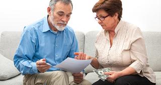 Senior couple going over savings © Alexander Raths/Shutterstock.com
