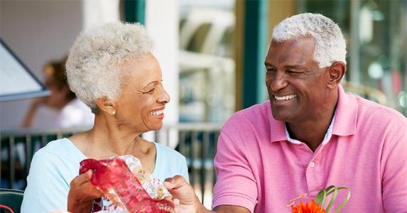Senior husband giving gift to wife | SpeedKingz/Getty Images