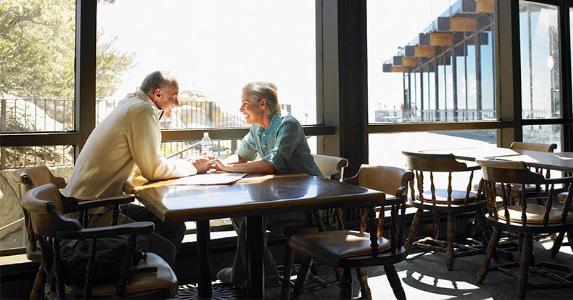 Less tax, more retirement saving with IRA account Senior couple seated at a restaurant table | Siri Stafford/Getty Images