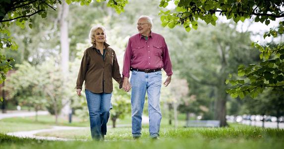 Insurance you may be throwing money away on Senior couple walking under tree cover | Stevecoleimages/Vetta/Getty Images
