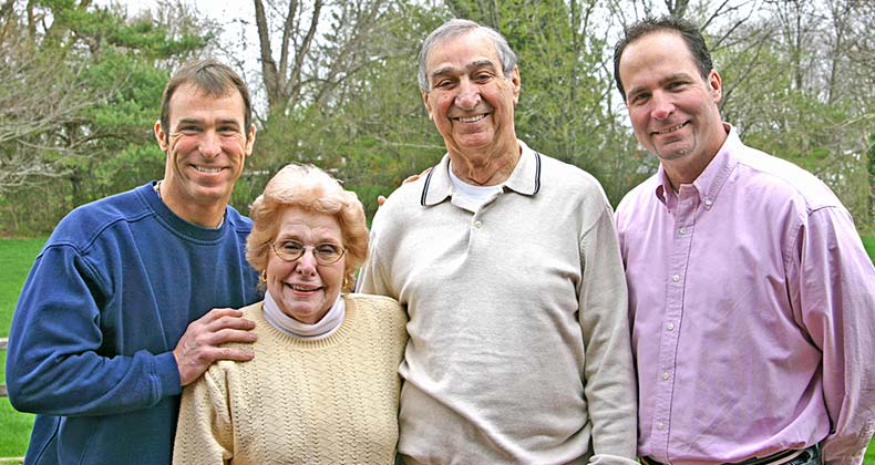 Reverse mortgage and telling your adult kids Senior parents with two adult sons © sonya etchison/Shutterstock.com