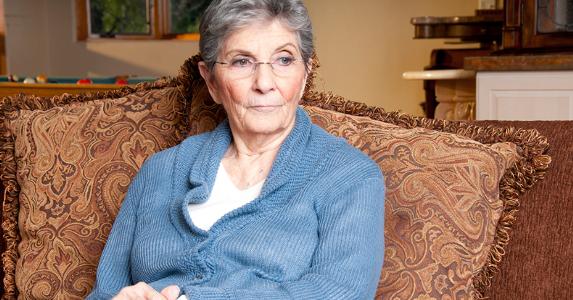 Senior woman seated on her couch