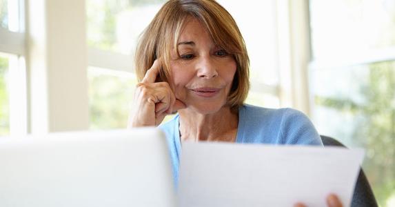 Senior woman looking at her paperwork © iStock