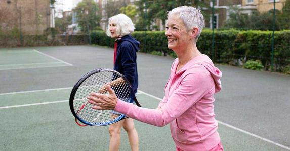 Retirement plan contribution limits Senior women playing tennis | Nick David/Getty Images