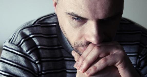 How to obtain a credit check for a personal loan Man deep in thought © Themalni/Shutterstock.com