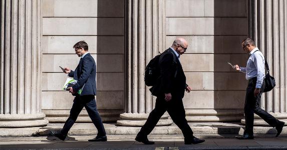 Financial workers walking down street | Bloomberg/Getty Images