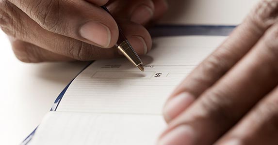 Writing 'bad' checks Writing 'bad' checks | REB Images/Blend Images/Getty Images