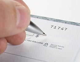 Accepting checks © Nikola Bilic/Shutterstock.com