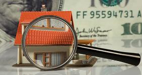 Small toy house with magnifying glass © Guy Shapira/Shutterstock.com