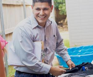 Smiling A/C technician | Steve Debenport/E+/Getty Images