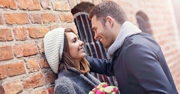 Bankrate survey finds the high cost of love Smiling couple leaning to each other | Kamil Macniak/Shutterstock.com
