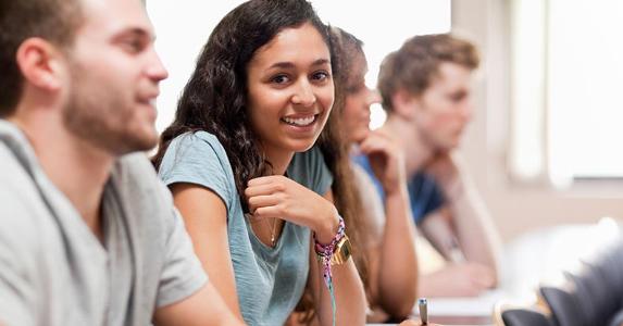 Smiling female student in classroom © WavebreakmediaMicro - Fotolia.com