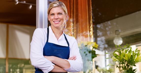 Smiling woman shopkeeper © Diego Cervo/Shutterstock.com