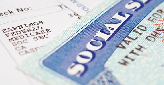Social security card and paycheck © chuck - Fotolia.com