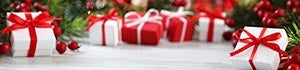 Presents wrapped in red and white paper under the tree © iStock