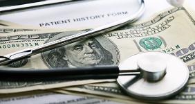 Stethoscope on 100 bills with history form © isak55/Shutterstock.com