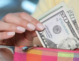 strategies-for-savers-4-spend-lg Woman pulling $50 bill from her wallet