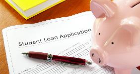Student loan application piggy bank on desk © zimmytws/Shutterstock.com