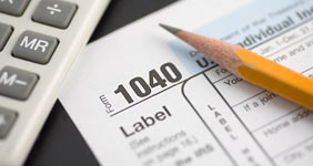 A 1040 form, a sharpened pencil and a calculator