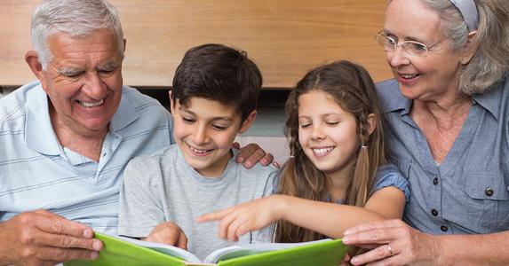 Grandparents reading with grandkids © wavebreakmedia/Shutterstock.com