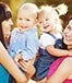 Two women holding children © GTeam/Shutterstock.com