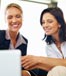 two women looking at laptop