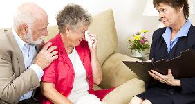 Upset elderly husband and wife meeting with an agent © Lisa F. Young/Shutterstock.com