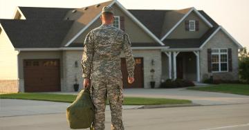Veteran standing with bag outside of home | Veterans United