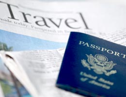 Travel section of newspaper and a passport