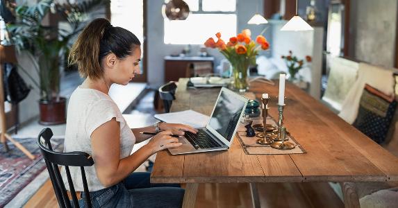 How to get an IRA distribution from your bank Woman sorting out finances on her laptop at home | Maskot/Getty Images
