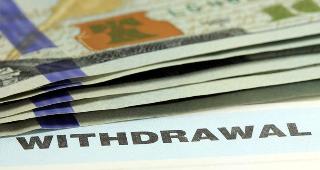 Withdrawal slip and money © larry1235/Shutterstock.com