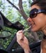 woman applying lipstick in car