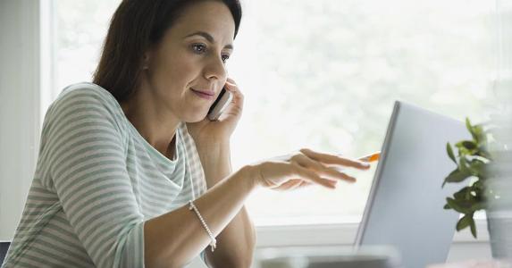Smart to try loan modification in bankruptcy? Woman checking data on her PC | HeroImages/Hero Images/Getty Images