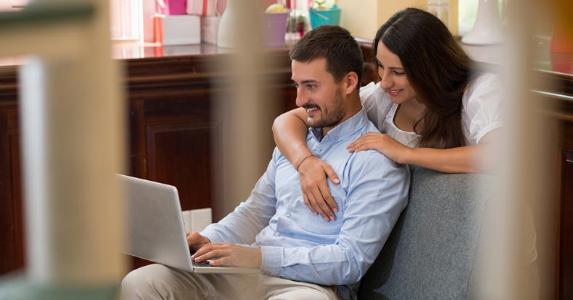 2 ways to get life insurance without a physical Couple looking at something on their laptop | iStock.com/DragonImages