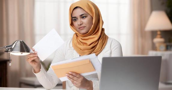 Fraud alerts: guarding your identity and credit Woman going through her mail | Blend Images/Hill Street Studios/Getty Images