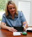 Woman pays bills at home